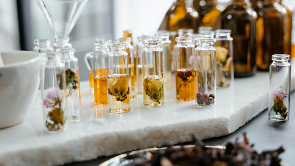 Illustration of perfume bottles with text 'Complete Guide for Aspiring Entrepreneurs' representing starting a perfume business